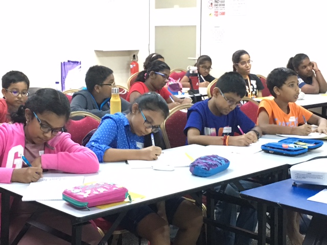 Focused students at Sigaram - Wordsmith Learning Hub engaged in a Tamil tuition class, enhancing their language skills in a conducive learning environment.