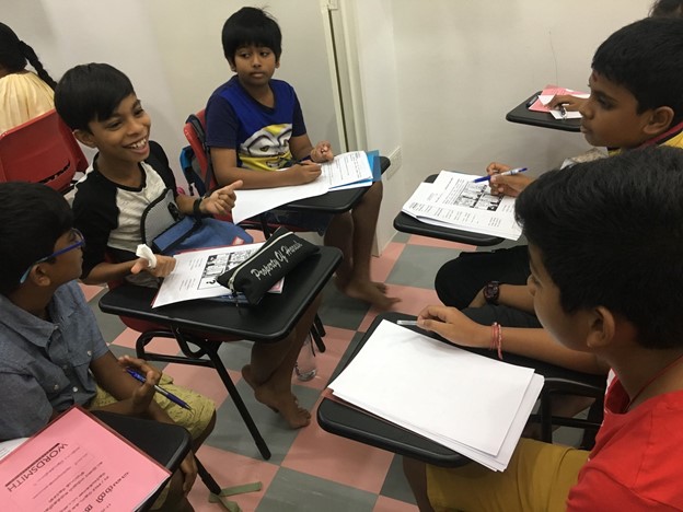Students engaged in Tamil tuition at Sigaram - Wordsmith Learning Hub, focusing on their study materials.