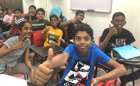 Active students in a class at Sigaram - Wordsmith Learning Hub with one student giving a thumbs up.